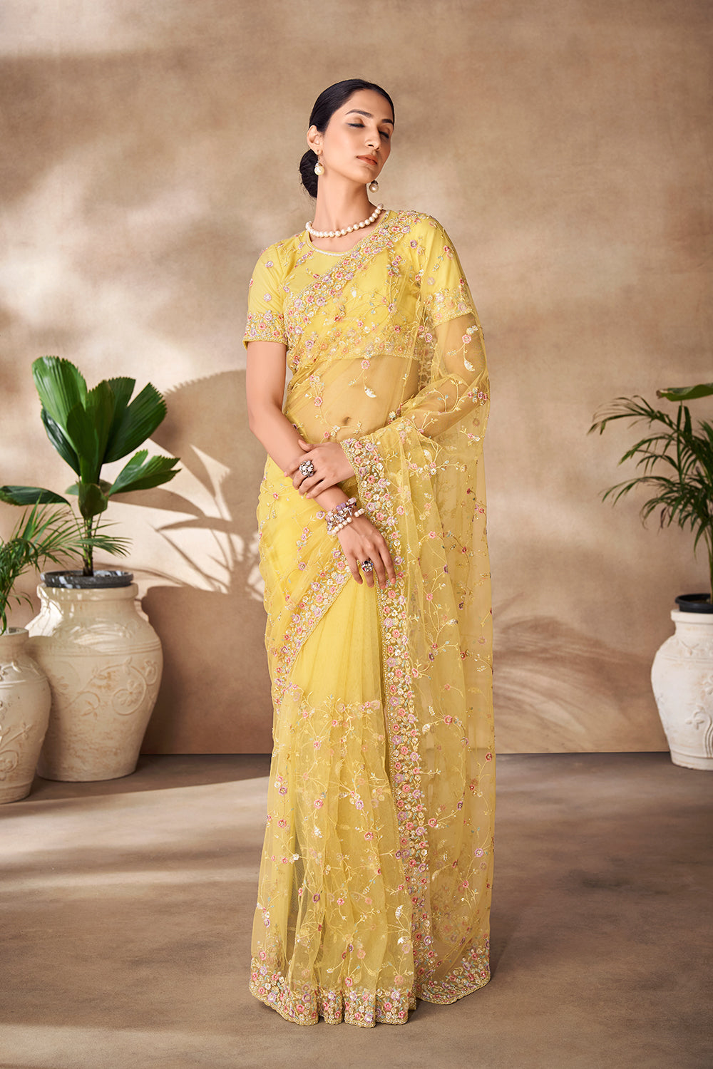 Beautiful Exclusive pastel shaded net saree with detailed work of sequins, thread and zarkan