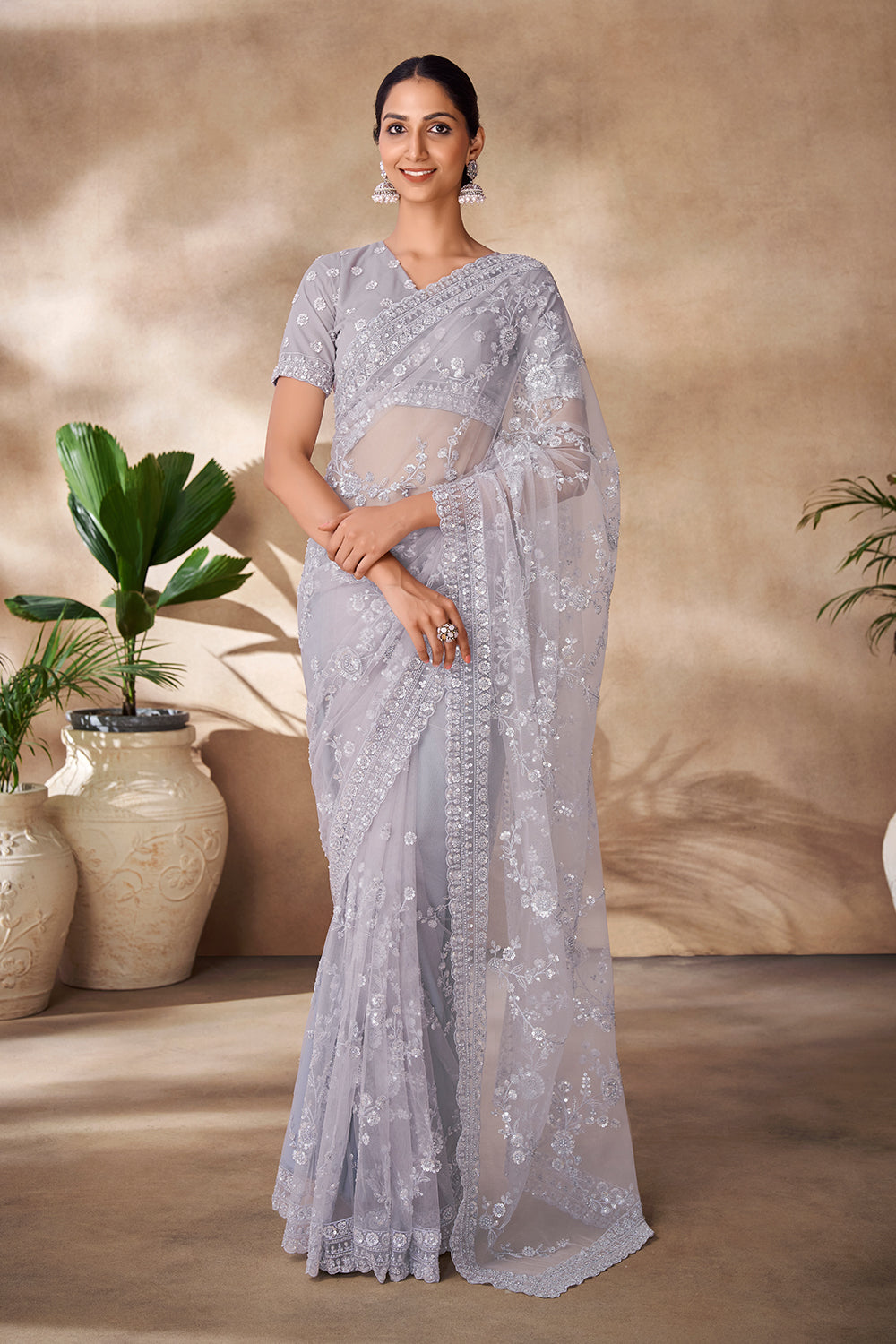 Beautiful Exclusive pastel shaded net saree with detailed work of sequins, thread and zarkan