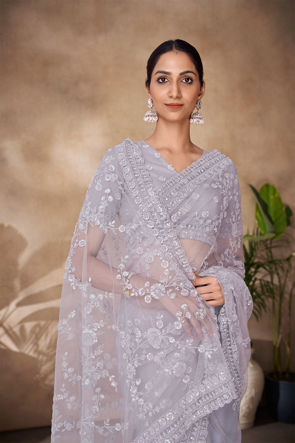 Beautiful Exclusive pastel shaded net saree with detailed work of sequins, thread and zarkan